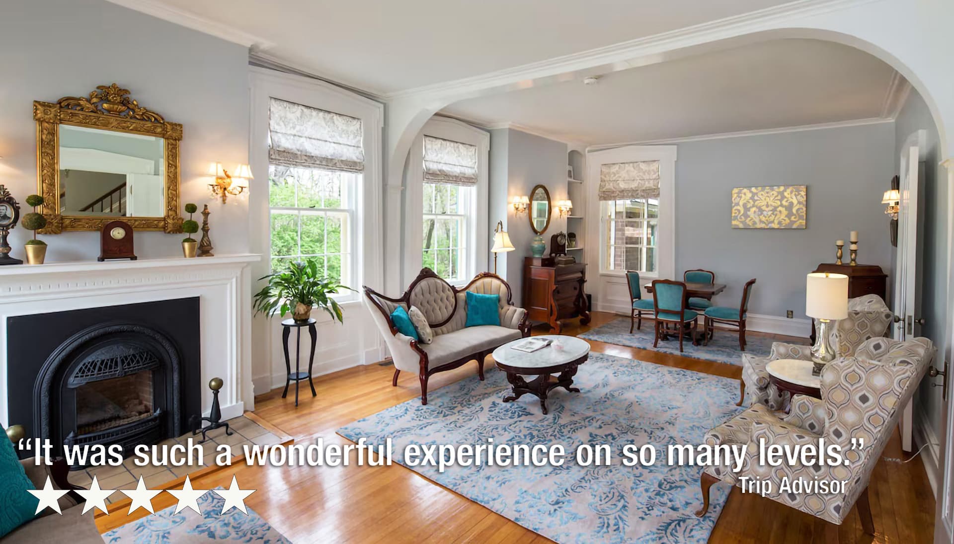 A cozy living room featuring elegant furniture, a fireplace, and large windows.